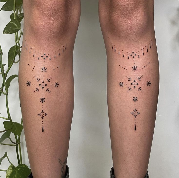 the legs are covered with tattoos on them