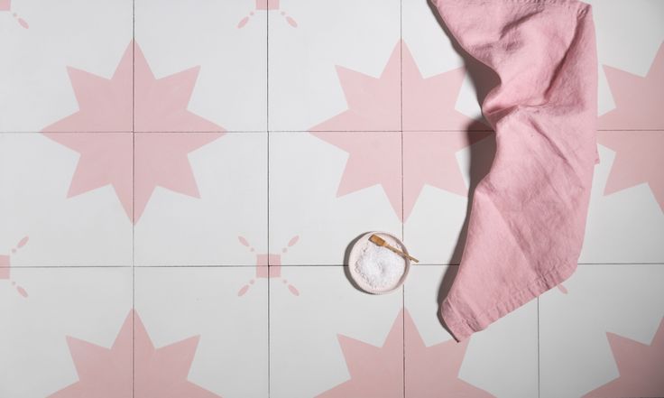 a pink and white wall with stars on it, next to a pair of scissors