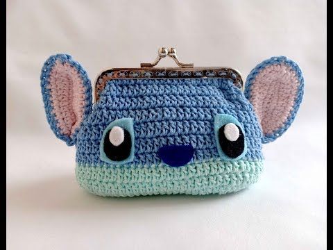 a crocheted purse with ears and eyes