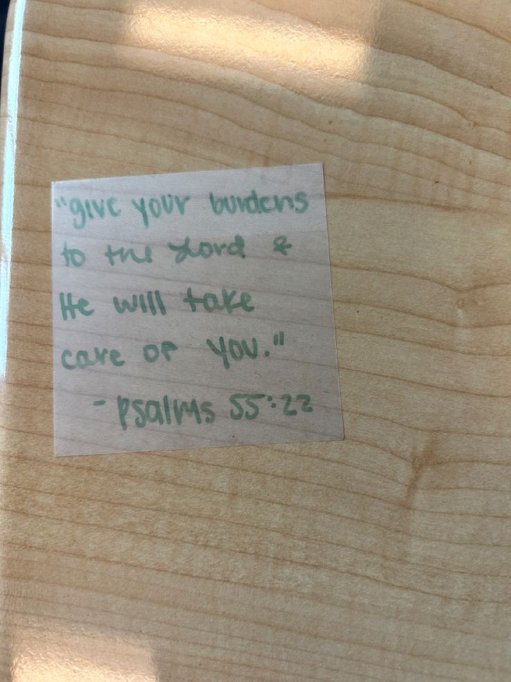 a piece of paper that has been placed on top of a wooden board with words written on it