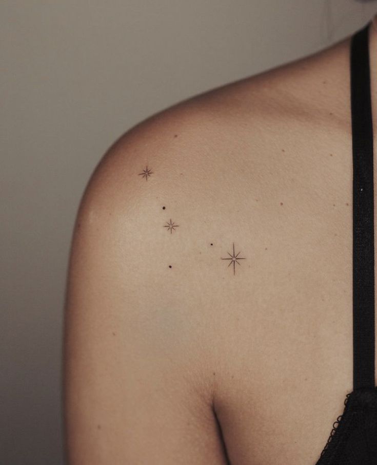 a woman's shoulder with small stars on it