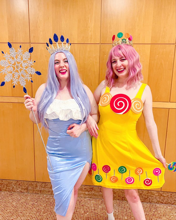 two women dressed in costumes posing for the camera