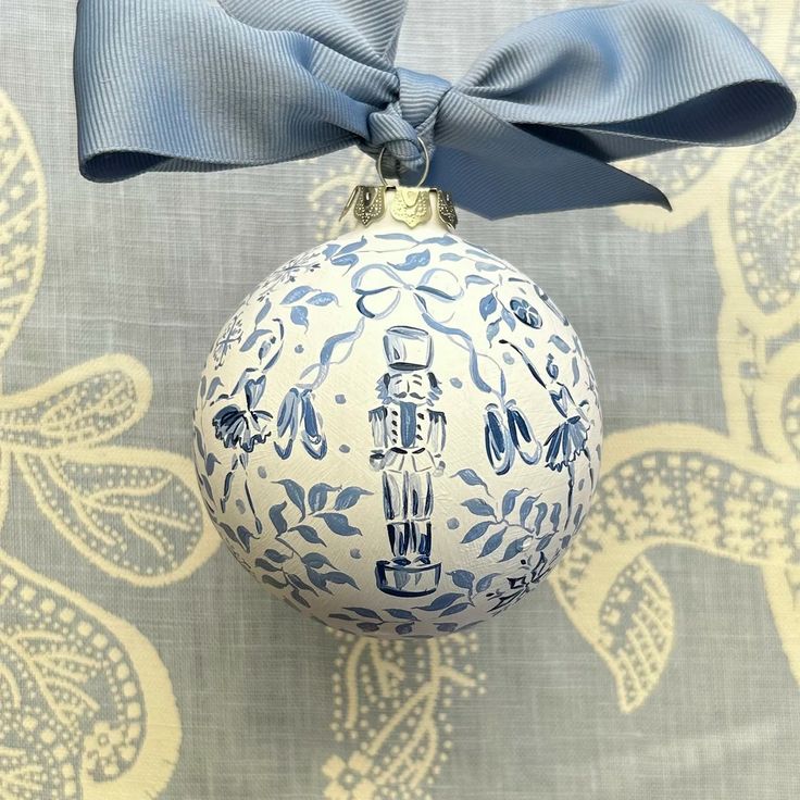 a blue and white ornament with a bow on it