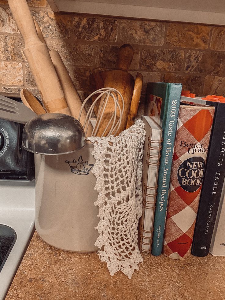 kitchen utensils and cookbooks are sitting on the counter