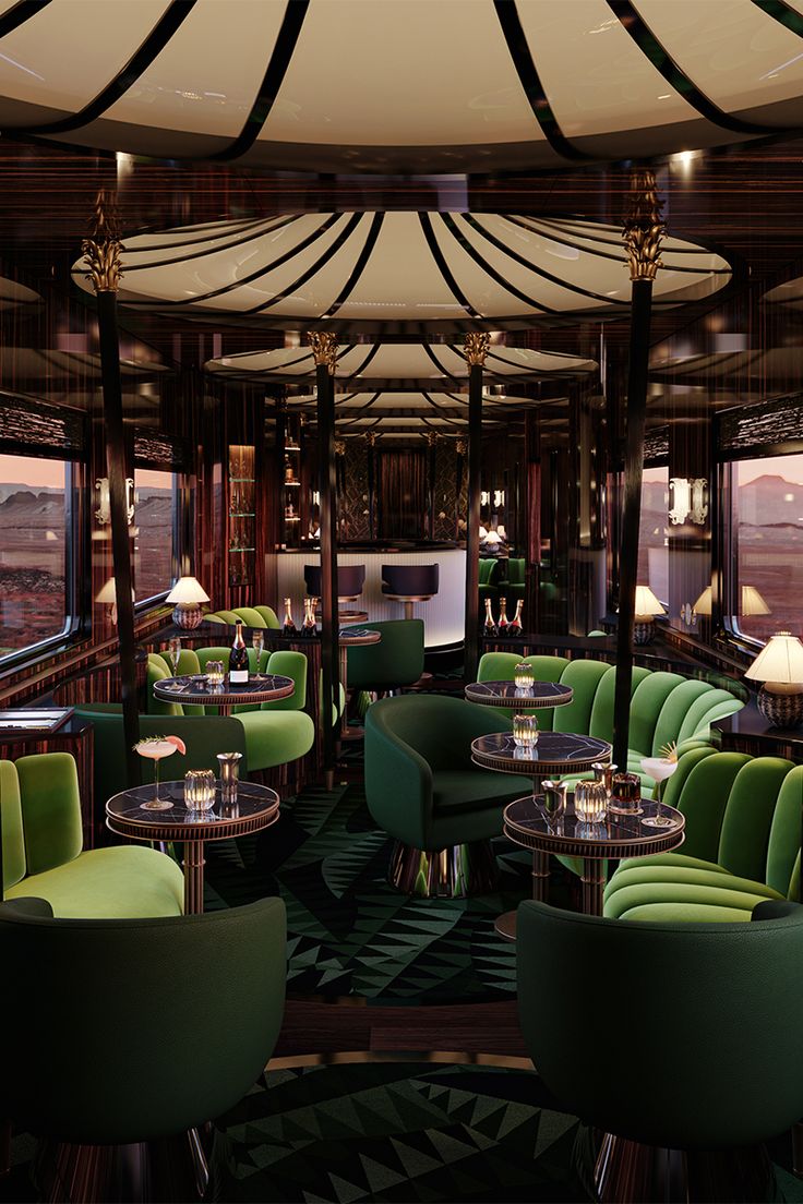 the interior of a restaurant with green chairs and tables in front of a large window