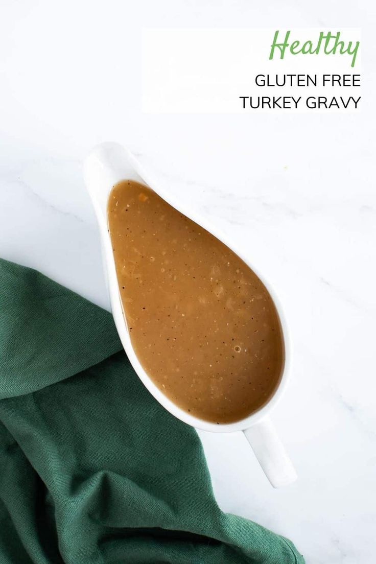 a gravy in a white serving dish on a green napkin with the words healthy gluten free turkey gravy