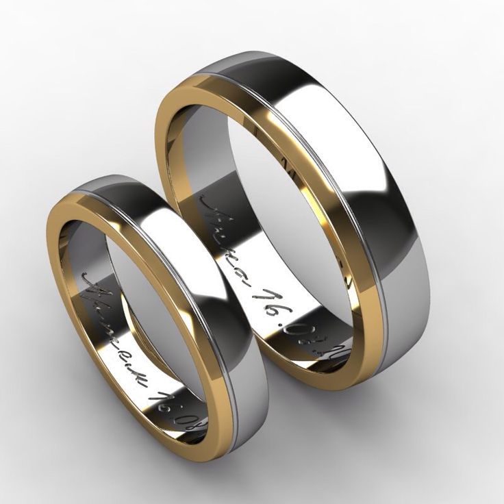 two gold and silver wedding rings with names engraved on the sides, set against a white background