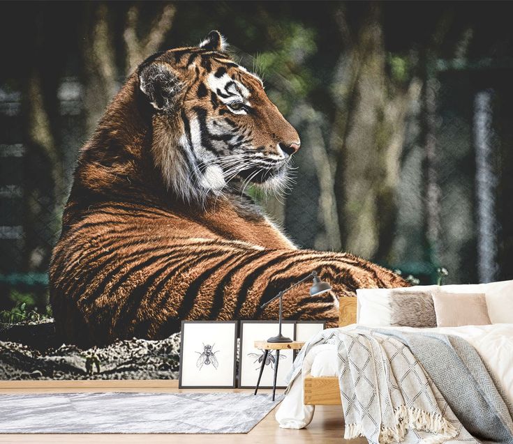 a large tiger sitting on top of a wooden floor