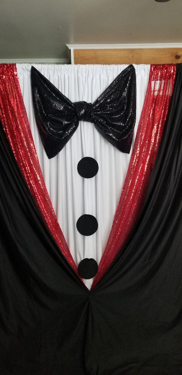 a black and white tuxedo backdrop with red sequins