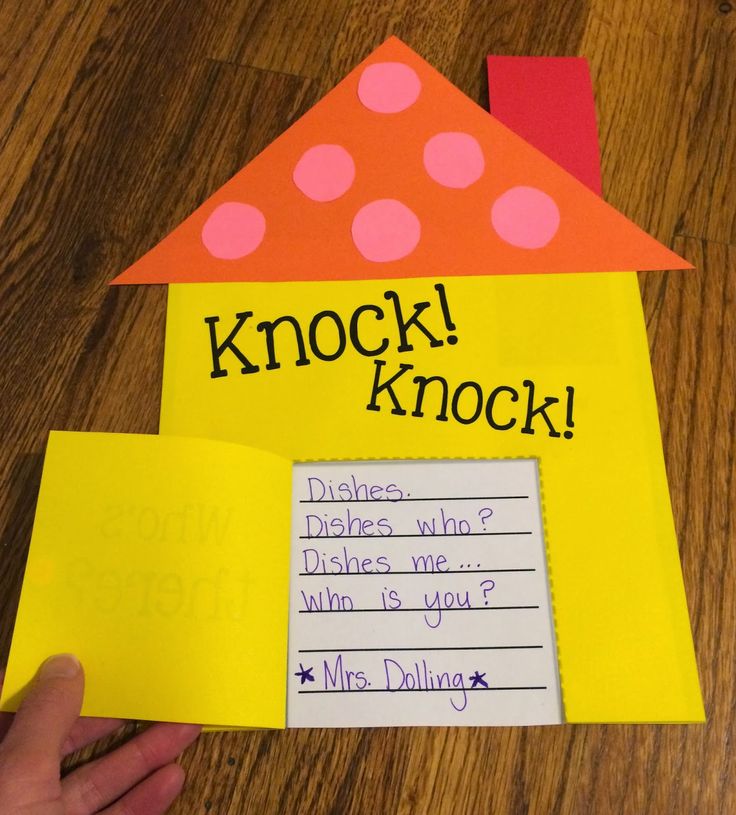 a child's hand holding up a piece of paper with the words knock knock on it