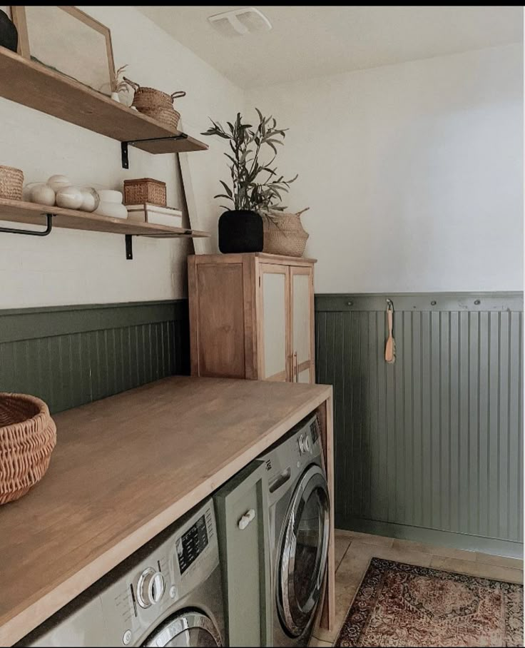 a washer and dryer in a room with green paneling on the walls