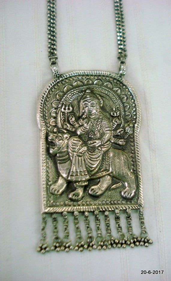 Vintage tribal silver necklace pendant from Rajasthan India. Great workmanship, Good for jewellery collection. Subject of this pendant is hindu goddess durga ma.Note - Please check pictures care fully for more detail.chain length - 55 cm (22") we can adjust the length.pendant size - 13/7.5 cm (5.1/2.9")weight - 138 grams material - silver. Silver Oxidized Temple Necklace For Puja, Silver Spiritual Temple Necklace For Puja, Spiritual Silver Temple Necklace For Rituals, Silver Temple Necklace For Puja, Silver Spiritual Necklaces For Navratri, Spiritual Silver Necklaces For Navratri, Silver Hallmarked Temple Necklace For Festivals, Silver Amulet Necklaces For Puja, Silver Amulet Pendant Temple Necklace