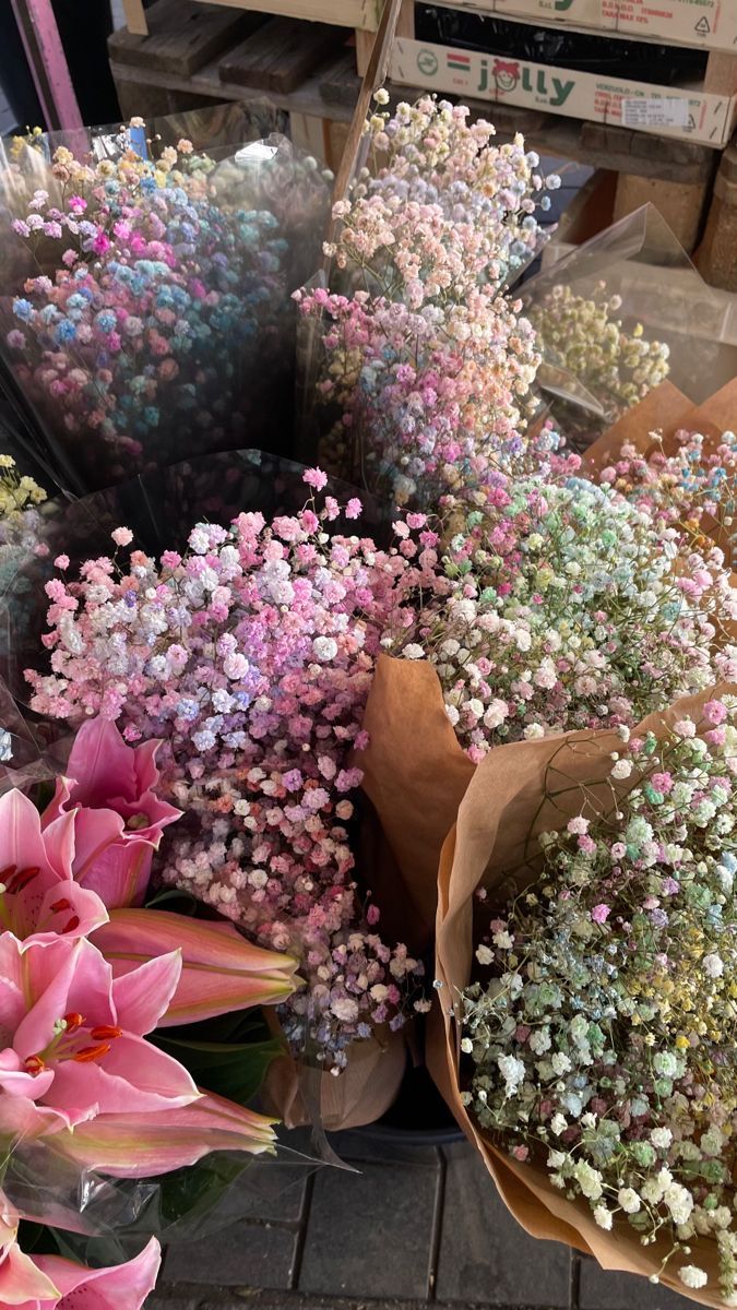 many different types of flowers on display for sale