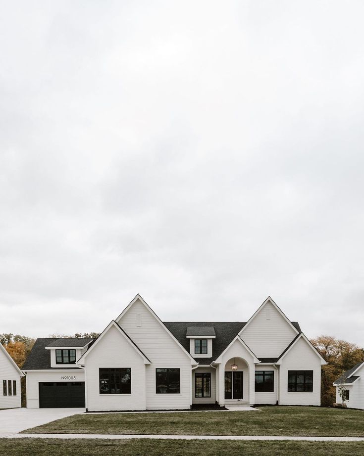 a large white house with two garages