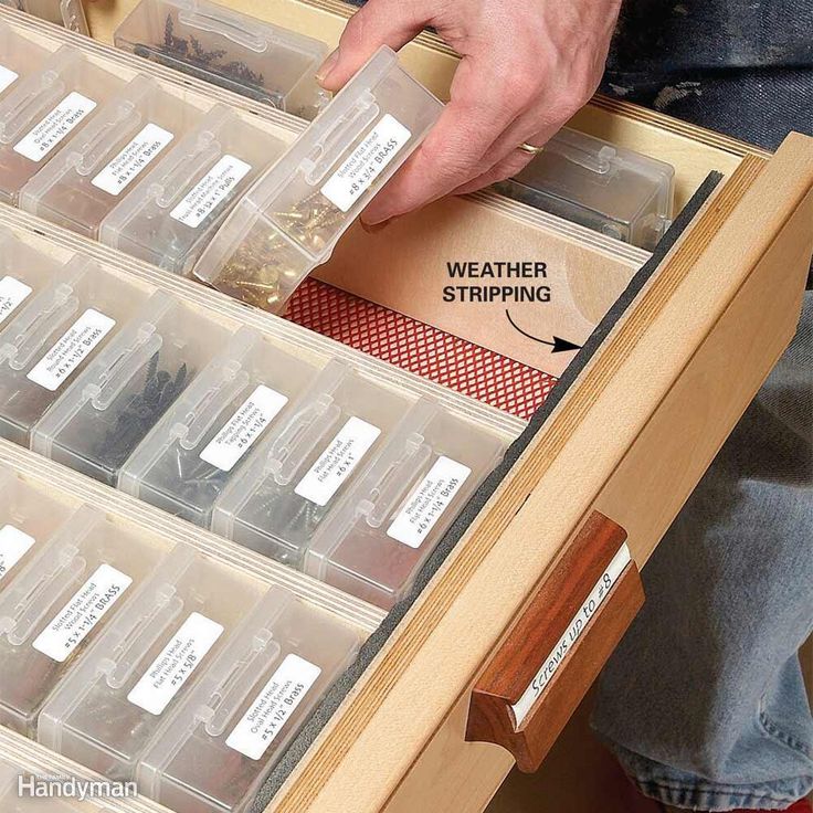 the drawer is filled with plastic storage containers and labeled labels for different types of items