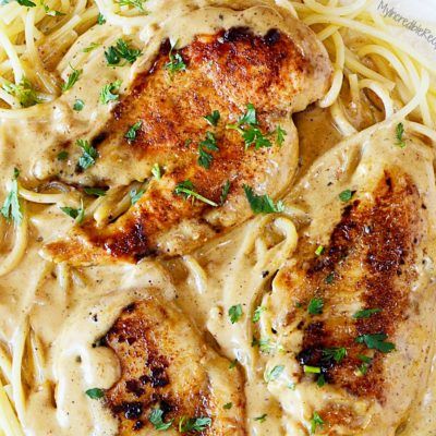 chicken with creamy sauce and noodles on a plate