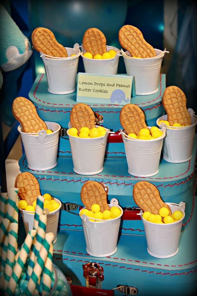 there is a cake made to look like a train track with cookies in buckets