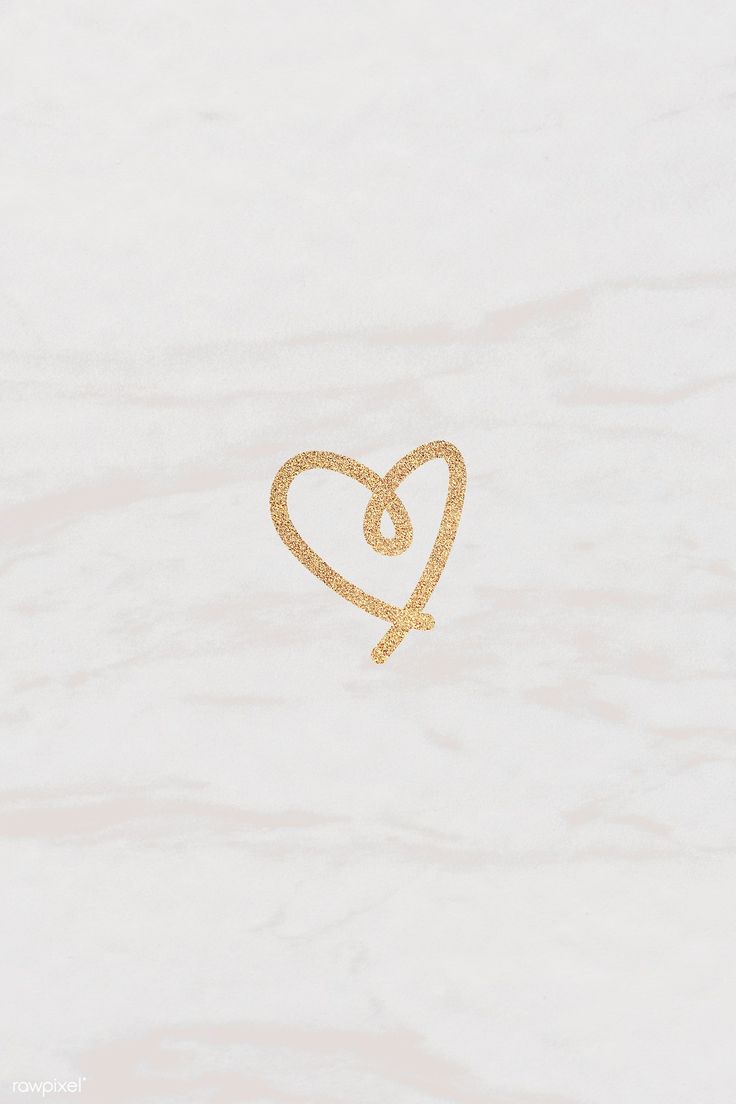 a gold heart with a knot on it's end is shown in the middle of a white marble surface