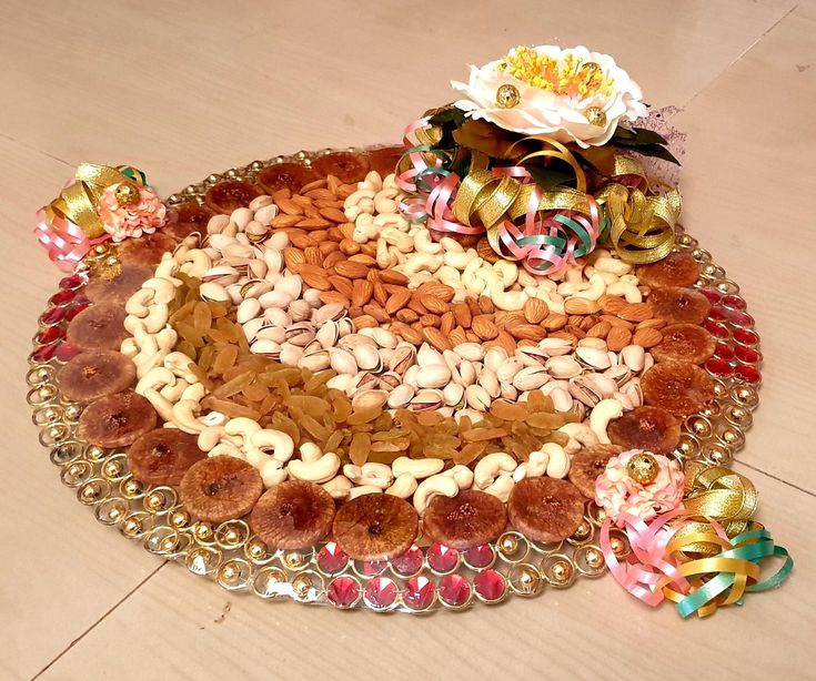 there is a platter that has nuts and candy on it, along with other decorations