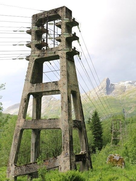 an old wooden tower in the middle of a field