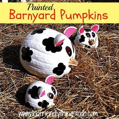 painted barnyard pumpkins with black and white polka dots on them in the hay