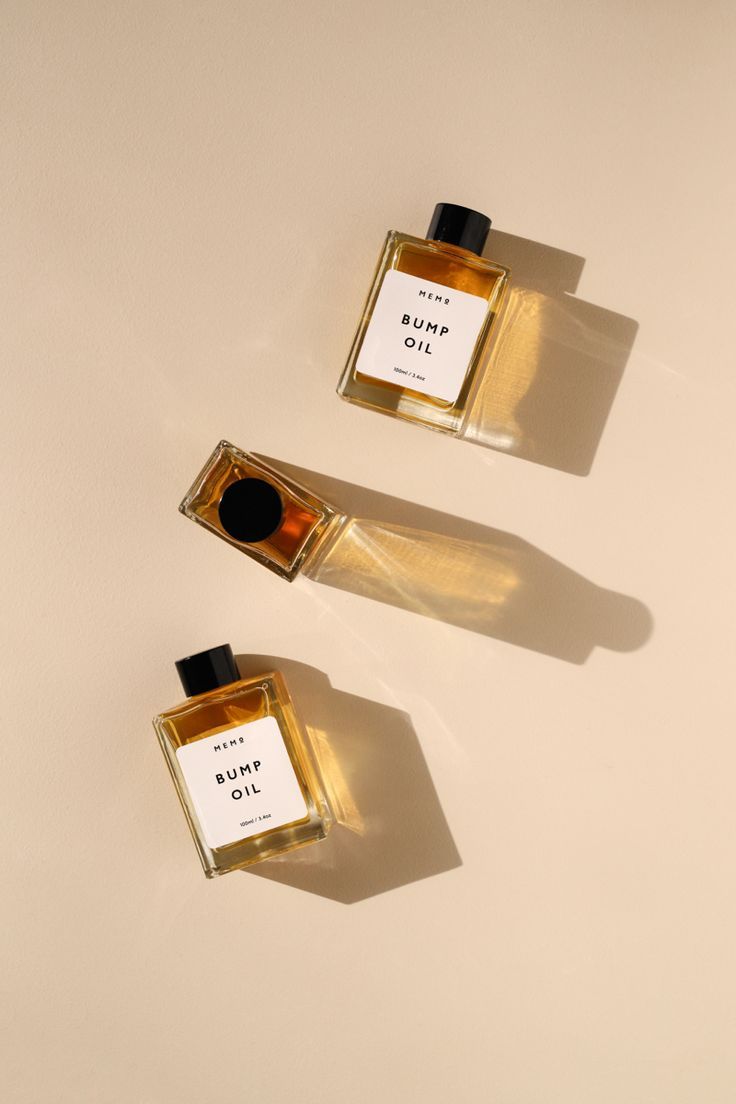 two bottles of perfume sitting next to each other