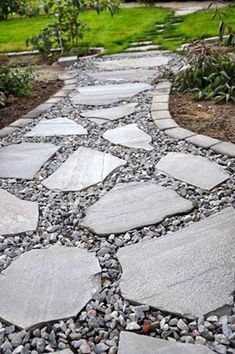 a stone path in the middle of a garden