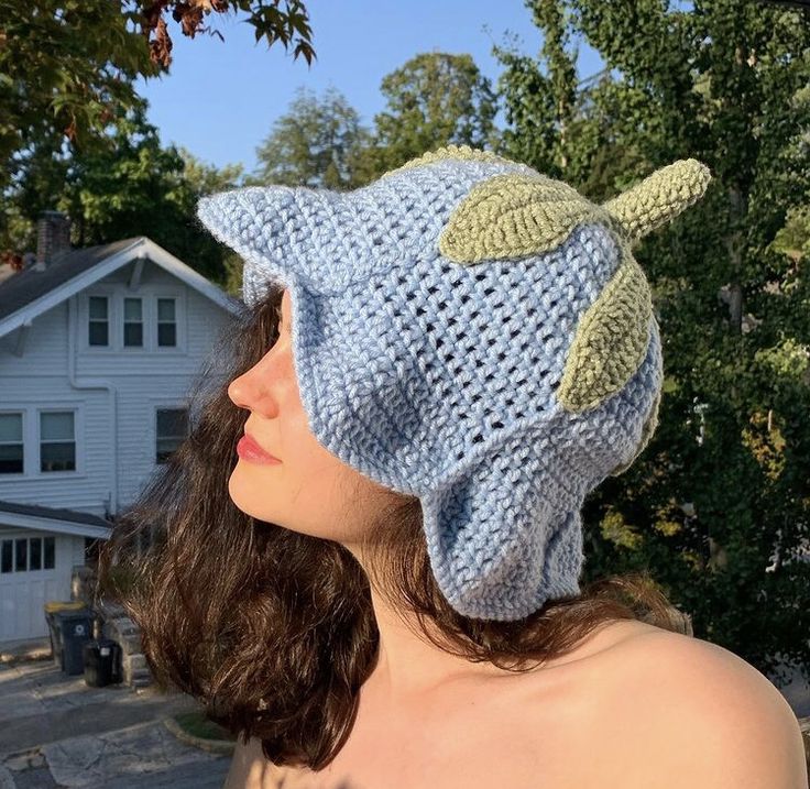 a woman wearing a knitted hat with a fish on it