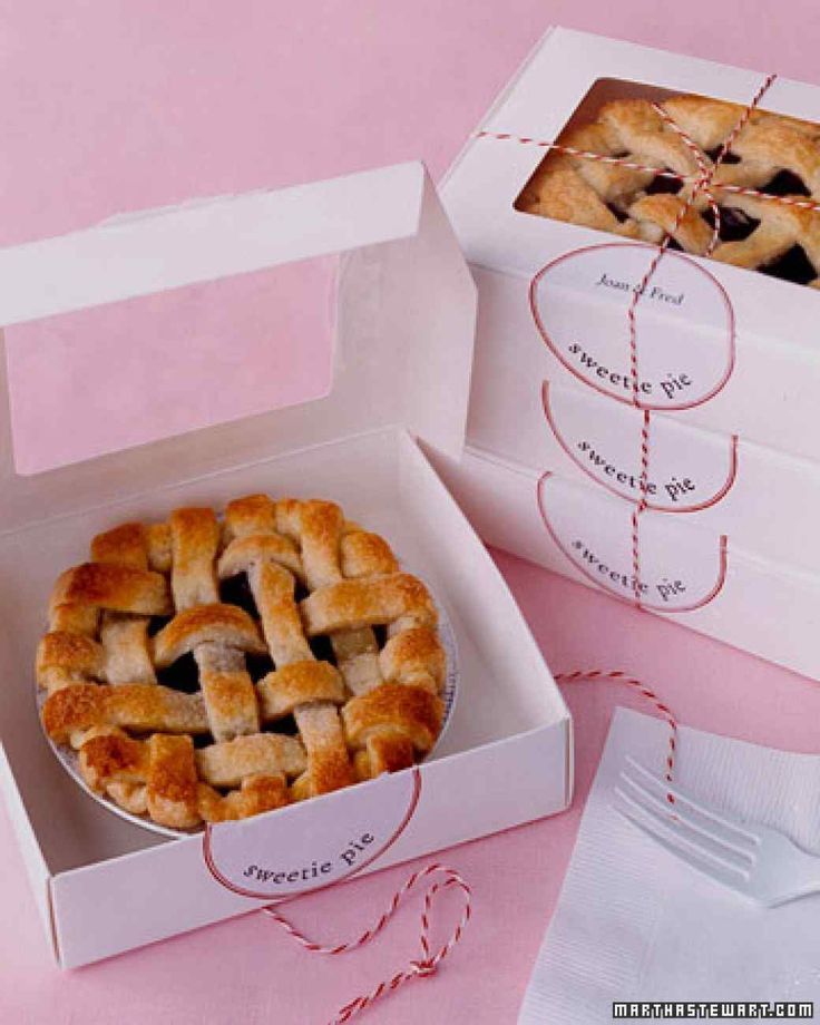 two boxes with pies in them sitting on a table