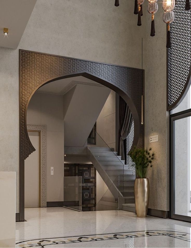 an elegant foyer with marble flooring and chandelier