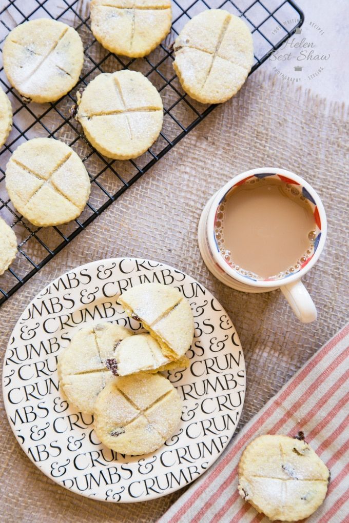 some cookies are on a plate next to a cup of coffee and a cooling rack