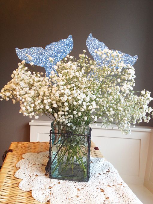 a vase filled with white flowers on top of a table