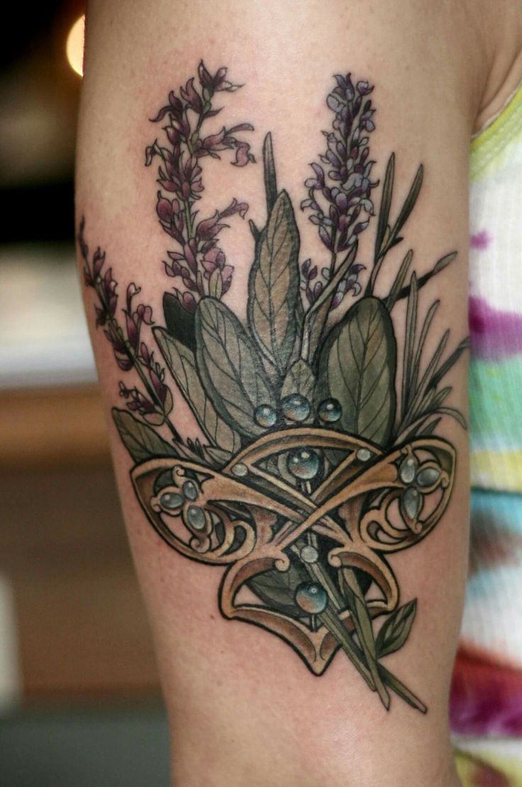 a woman's thigh with flowers and scissors on her left side tattooing it