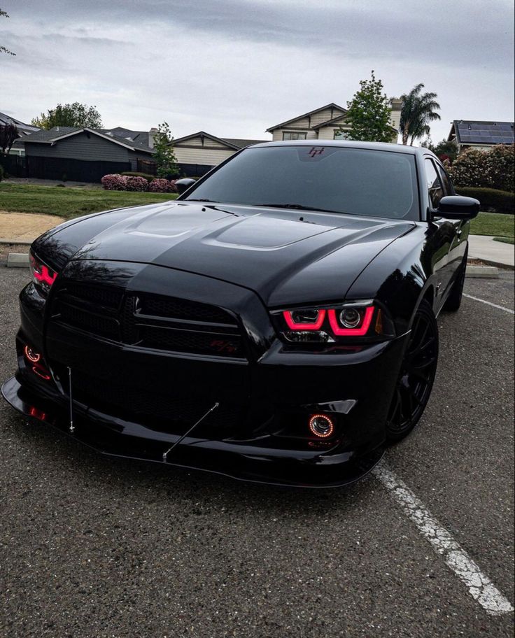 a black sports car parked in a parking lot