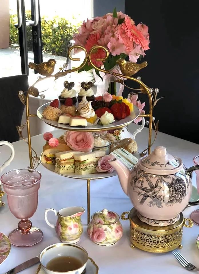 a table topped with lots of different types of food and cups on top of it