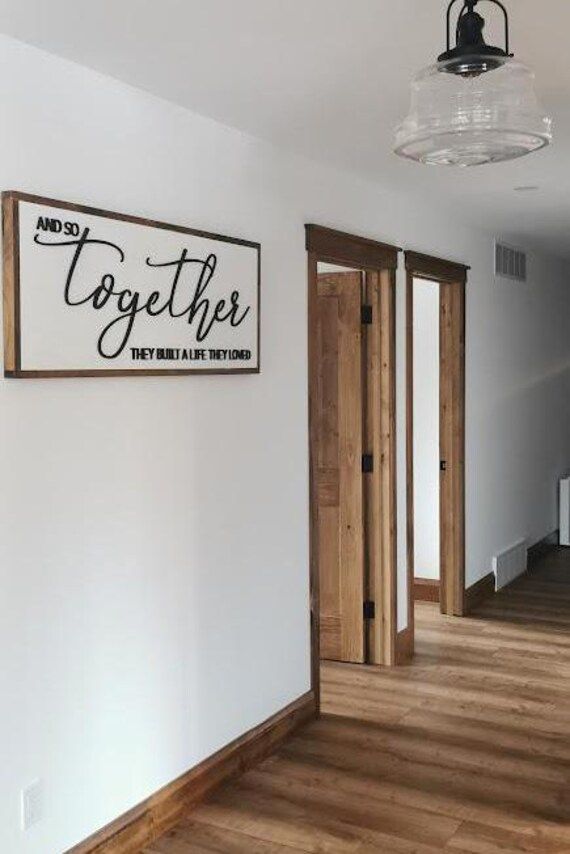 there is a sign that says together on the wall next to two doors and a light fixture