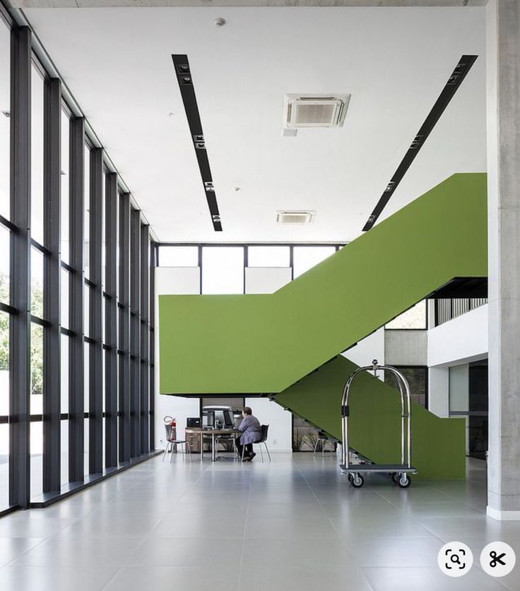 a green stair case in an office building