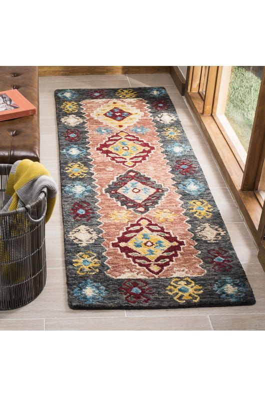 a large rug in the middle of a living room next to a chair and window