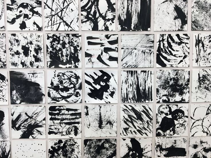 many black and white paintings on a wall