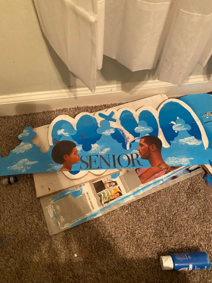 a skateboard that is laying on the ground next to some papers and water bottles