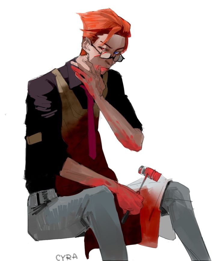 a man with red hair and glasses sitting on a chair holding his hand to his face