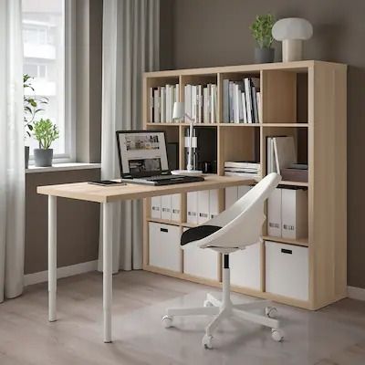 a white chair sitting in front of a desk with bookshelf on top of it