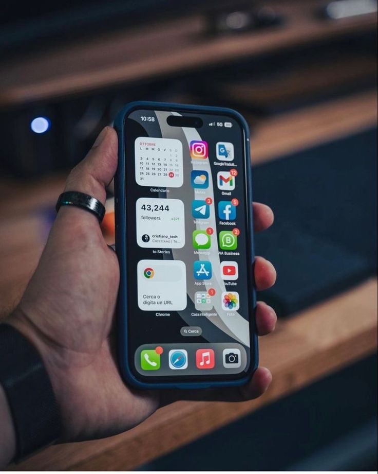 a person holding an iphone in their hand with icons on the screen and app icons on the back