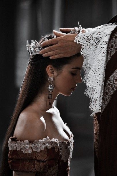 a woman wearing a tiara standing next to a man