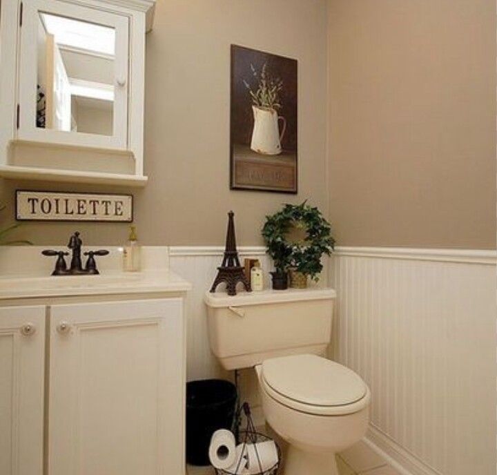 a white toilet sitting in a bathroom next to a sink