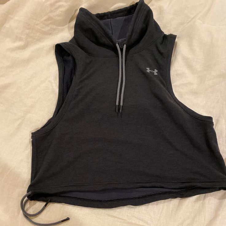 Sweatshirt Feel, Sleeveless, Ventilated Back, Drawstring In Turtle Neck And Cropped Bottom. Great Tip. Dark Gray/Black To Match All Your Gear! Never Washed Or Worn!! New Without Tags! - Wide Arms And Cropped Fit. 18” L 21” Opening Bottom. 14” Shoulder To Shoulder. 11” Across Neck Hole. Airflow Bit In Back. All Offers Welcome! Bundle To Save Gray Sleeveless Gym Top, Gray Sleeveless Tops For Gym, Under Armour Stretch Sportswear Tops, Under Armour Sportswear Tops For Sports, Gray Tank Top For Workout, Under Armour Athleisure Sports Top, Casual Sleeveless Gray Activewear, Under Armour Stretch Tops For Gym, Under Armour Stretch Gym Tops