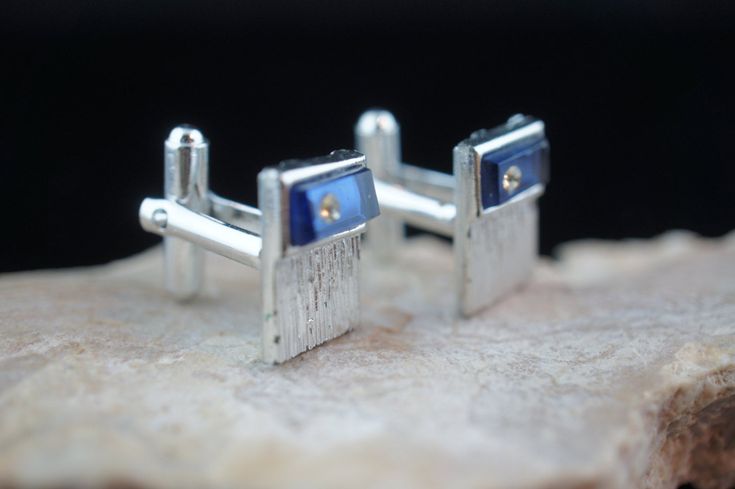 This is the perfect option for those who like cool, unique jewelry and the luxury, shine of gold and silver tone. This cufflinks are well made, cute and/or elegant in design, and very desirable. The tops have engraving . The one of cuff links are decorated with blue stones and white cz. The clasps are in perfect working condition. ♥ Age/era: Circa 1970s - 1980s. ♥ There is no hallmark. ♥ The cufflinks are about 7/8 inches by 9/16 inches, and 5/8'' by 2/4''. Every one interested in the jewelry sh Adjustable Screw Back Jewelry Gift, Adjustable Shiny Finish Jewelry As A Gift, Formal Sapphire Jewelry In Metal, Silver Business Jewelry With Polished Finish, Adjustable Formal Jewelry With Birthstone, Cubic Zirconia Screw Back Jewelry For Gifts, Sterling Silver Jewelry With Screw Back For Gift, Nickel-free Sapphire Jewelry For Formal Occasions, Formal Sterling Silver Jewelry With Screw Back