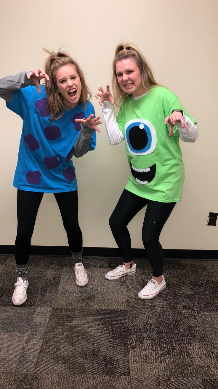 two young women dressed in costumes posing for the camera with their hands up and eyes open