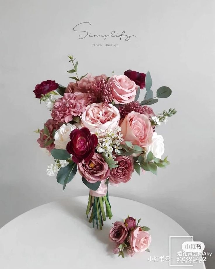 a bouquet of flowers sitting on top of a white table