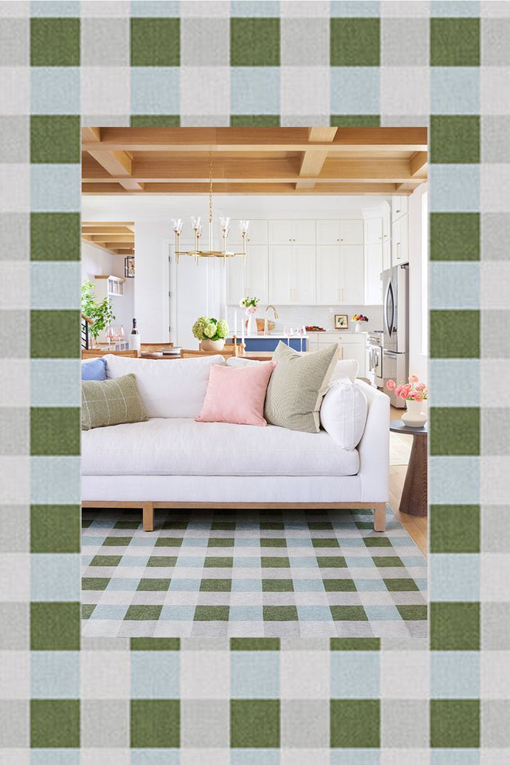 a living room filled with furniture and a checkered rug on top of a wooden floor